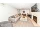 Cozy basement with plush seating, fireplace, and neutral carpeting at 5681 Carrollton Ave, Indianapolis, IN 46220