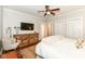 Serene bedroom with neutral tones, a ceiling fan, and ample closet space for storage at 5681 Carrollton Ave, Indianapolis, IN 46220