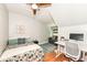 Inviting bedroom includes modern ceiling fan, a bed, and a work space at 5681 Carrollton Ave, Indianapolis, IN 46220