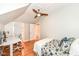 Comfortable bedroom features natural lighting, modern ceiling fan, and a small workspace at 5681 Carrollton Ave, Indianapolis, IN 46220