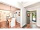Inviting dining room featuring hardwood floors, a modern chandelier, and seamless flow into the kitchen at 5681 Carrollton Ave, Indianapolis, IN 46220