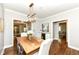 Elegant dining room with hardwood floors, stylish lighting, and a wine cooler at 5681 Carrollton Ave, Indianapolis, IN 46220