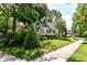 Beautiful home with mature trees, manicured lawn, and charming curb appeal at 5681 Carrollton Ave, Indianapolis, IN 46220