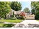 Charming home with landscaped yard, mature trees, and a two-car garage at 5681 Carrollton Ave, Indianapolis, IN 46220