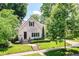 Beautiful white brick home with a well-manicured lawn and lush landscaping at 5681 Carrollton Ave, Indianapolis, IN 46220
