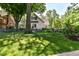 Charming two-story home with lush green lawn and metal fence, perfect for a Gathering at 5681 Carrollton Ave, Indianapolis, IN 46220