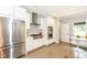 Well-equipped kitchen with stainless steel appliances, white cabinets, and a cozy breakfast nook at 5681 Carrollton Ave, Indianapolis, IN 46220