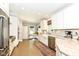 Bright, modern kitchen with white cabinetry, stainless steel appliances, and a charming breakfast nook at 5681 Carrollton Ave, Indianapolis, IN 46220