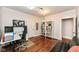 Cozy home office boasts hardwood floors, bright lighting, and a built-in bookcase at 5681 Carrollton Ave, Indianapolis, IN 46220