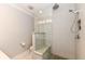 Modern walk-in shower with sleek tiles, a built-in bench, and contemporary fixtures at 5681 Carrollton Ave, Indianapolis, IN 46220