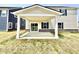 New construction home with a covered patio, stone accents, and grassy backyard at 581 Roosevelt St, Fortville, IN 46040