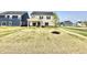 Home's backyard features newly planted tree, covered patio, and sliding doors to the interior at 581 Roosevelt St, Fortville, IN 46040