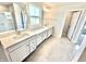 Bathroom with double sinks, tile flooring, framed mirrors, and walk-in shower and closet at 581 Roosevelt St, Fortville, IN 46040