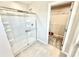 Clean bathroom with a glass-enclosed shower and tile flooring next to a walk-in closet at 581 Roosevelt St, Fortville, IN 46040