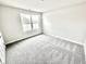 Inviting bedroom with plush carpet and a bright window, perfect for relaxation at 581 Roosevelt St, Fortville, IN 46040