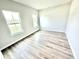 This bedroom features two windows and neutral walls complemented by stylish wood-look floors at 581 Roosevelt St, Fortville, IN 46040