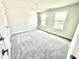 Neutral bedroom with plush carpet, bright windows, and fresh paint at 581 Roosevelt St, Fortville, IN 46040