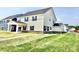 Side view of a two-story home with stone foundation, siding, and an attached two-car garage at 581 Roosevelt St, Fortville, IN 46040