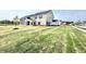 New two-story home with siding, dark shutters, and a well-manicured lawn and landscaping at 581 Roosevelt St, Fortville, IN 46040