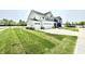 Desirable two-story home boasting a three-car garage, large grassy yard, and charming curb appeal at 581 Roosevelt St, Fortville, IN 46040