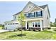 Well-maintained two-story home with a two-car garage, manicured lawn, and charming front porch at 581 Roosevelt St, Fortville, IN 46040