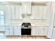 Stylish kitchen featuring stainless steel stove and white cabinets with quartz countertops at 581 Roosevelt St, Fortville, IN 46040