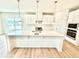 Bright kitchen with white cabinets, quartz countertops, and stainless steel appliances at 581 Roosevelt St, Fortville, IN 46040