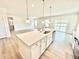Spacious kitchen island with stainless steel appliances and pendant lighting at 581 Roosevelt St, Fortville, IN 46040