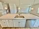 Kitchen island featuring a stainless steel sink and ample storage space at 581 Roosevelt St, Fortville, IN 46040
