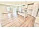 Modern kitchen featuring a large island, white cabinets, stainless appliances, and open layout to living area at 581 Roosevelt St, Fortville, IN 46040