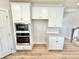 Modern kitchen with stainless steel built in oven and white cabinets at 581 Roosevelt St, Fortville, IN 46040