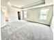 Spacious main bedroom featuring tray ceiling, plush carpet, and natural light at 581 Roosevelt St, Fortville, IN 46040