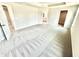 Large main bedroom with plush carpet, a tray ceiling, and a view to the ensuite and walk-in closet at 581 Roosevelt St, Fortville, IN 46040