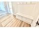 A close-up view shows a mudroom bench with coat hooks above, and storage below at 581 Roosevelt St, Fortville, IN 46040