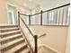The home features carpeted stairs with a wood and white railing, adding comfort and style at 581 Roosevelt St, Fortville, IN 46040