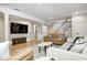 Finished basement featuring couches, a mounted TV, and a staircase at 6045 Haverford Ave, Indianapolis, IN 46220
