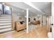 Finished basement with a staircase, couches, and a decorative carpet at 6045 Haverford Ave, Indianapolis, IN 46220