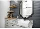 Stylish bathroom featuring shiplap wall, floating shelves, marble countertop and vessel sink at 6045 Haverford Ave, Indianapolis, IN 46220
