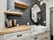 Modern bathroom with shiplap wall, floating shelves, and a vessel sink at 6045 Haverford Ave, Indianapolis, IN 46220