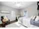 Well-lit bedroom with hardwood floors, large windows and comfortable furnishings at 6045 Haverford Ave, Indianapolis, IN 46220