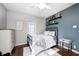 Bedroom featuring hardwood floors, natural light, and a decorative color accent wall at 6045 Haverford Ave, Indianapolis, IN 46220
