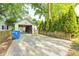 Long driveway leading to a detached single-car garage with room for parking and storage at 6045 Haverford Ave, Indianapolis, IN 46220