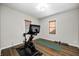 Bright exercise room featuring wood floors, natural light, and a stationary bike with workout equipment at 6045 Haverford Ave, Indianapolis, IN 46220