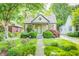 Charming home featuring a stone facade, manicured lawn, mature trees and beautiful landscaping at 6045 Haverford Ave, Indianapolis, IN 46220