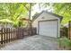 Exterior of a garage with attached pergola, and a quaint fence enclosing outdoor seating at 6045 Haverford Ave, Indianapolis, IN 46220