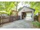 A detached single-car garage with an open door, a private fenced patio, and exterior storage at 6045 Haverford Ave, Indianapolis, IN 46220