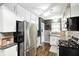 Modern kitchen featuring stainless steel appliances and sleek white cabinets at 6045 Haverford Ave, Indianapolis, IN 46220