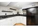 Kitchenette with white cabinets, a dark countertop, and black appliances at 6045 Haverford Ave, Indianapolis, IN 46220