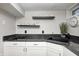 Kitchenette with white cabinets, dark countertops, and a black sink at 6045 Haverford Ave, Indianapolis, IN 46220