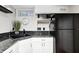 Kitchenette featuring white cabinets, granite countertops, and black appliances at 6045 Haverford Ave, Indianapolis, IN 46220